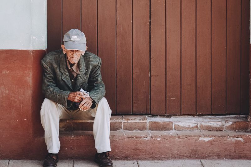 Sitting on steps pose for male senior